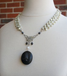 Necklace made with Victorian mourning locket and multi strands of mother of pearl beads