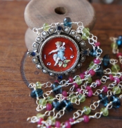Necklace made with multi colour gemstone chain and rare enamel cherub brooch